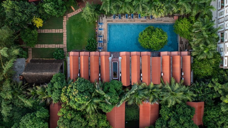 Top view of villas with swimming pool surrounded by trees