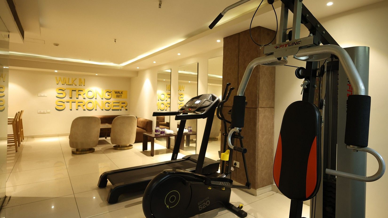 Well-equipped fitness center with gym machines at Hotel Saket 27.