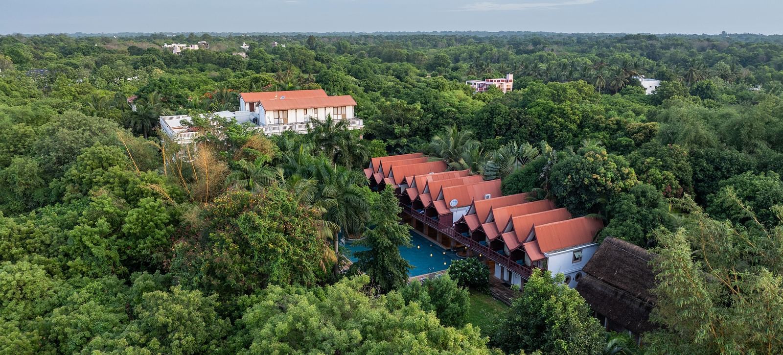 Top view of  the resort surrounded by trees.