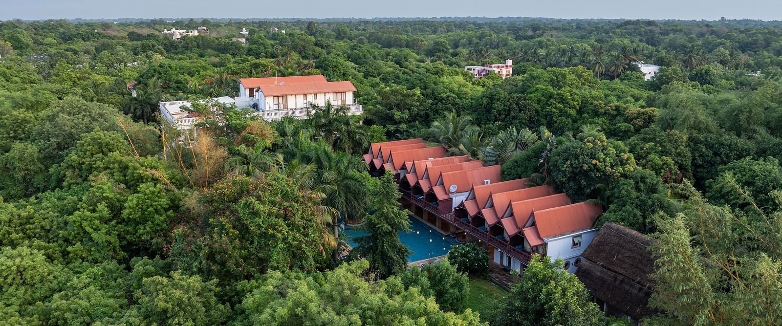 Top view of  the resort surrounded by trees.