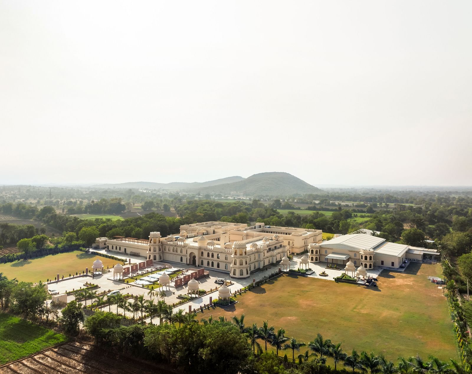 Aerial view of a Kesar Bagh Palace surrounded by greenery.