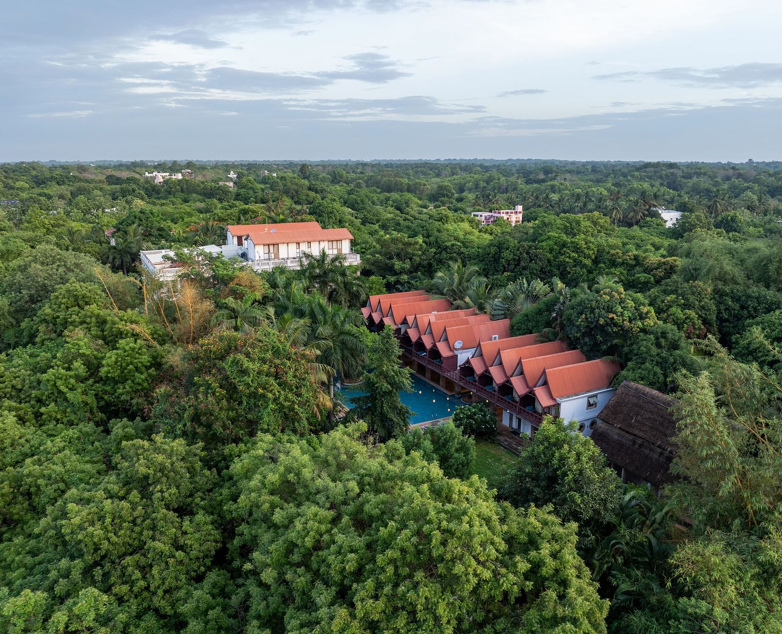 Top view of  the resort surrounded by trees.