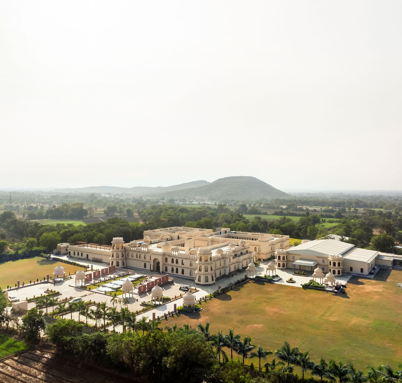 Aerial view of a Kesar Bagh Palace surrounded by greenery.