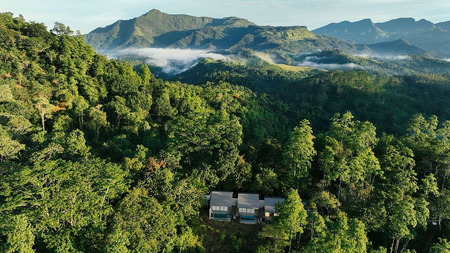 An aerial view of Celestial Hills - Villas & Suites by The Clarks amidst lush greenery during daytime
