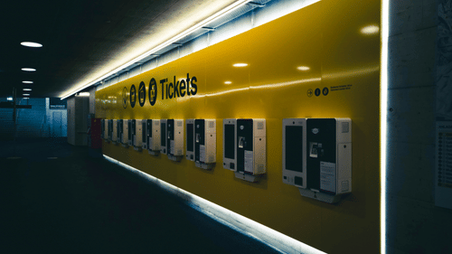 An overview of a ticket counter with led lights on it.