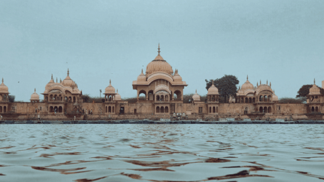 Historic temple architecture reflected in the river at Vrindavan.