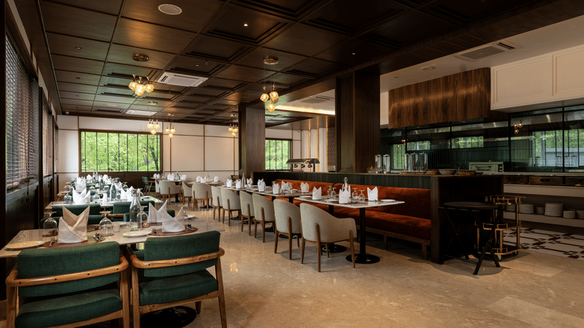 Fine dining restaurant at Mountnoor Sarovar Premiere, Pahalgam offering sophisticated interiors and relaxed seating.