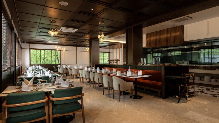 Fine dining restaurant at Mountnoor Sarovar Premiere, Pahalgam offering sophisticated interiors and relaxed seating.