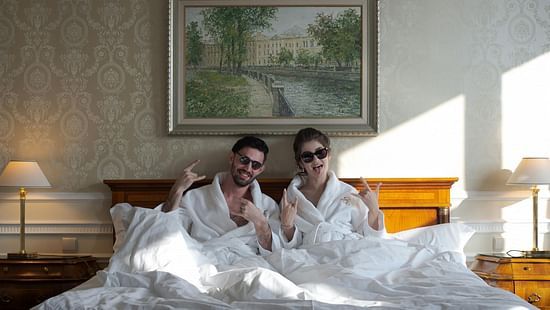 Interior view of a room with two people on the bed