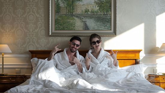 Interior view of a room with two people on the bed