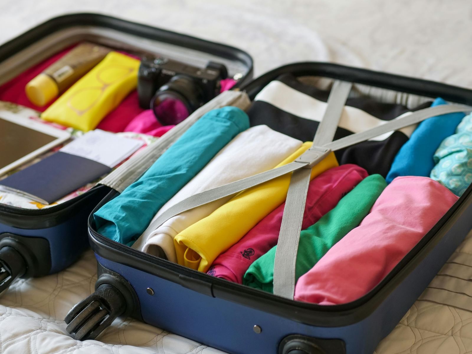 A suitcase packed with clothes and amenities