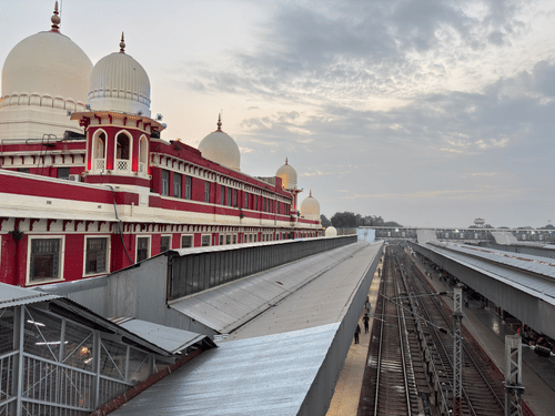A ariel view of the Charbagh Station, Lucknow. The red walls with its white peaks are visible along with the train tracks..