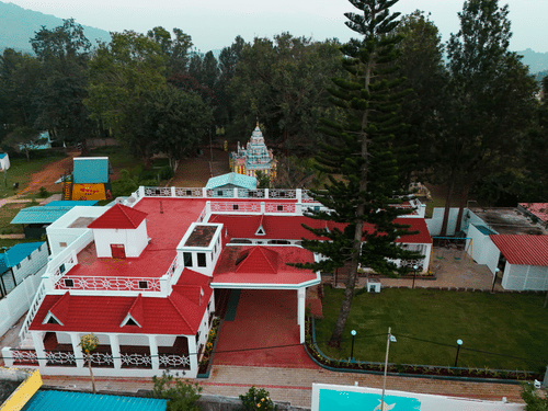 Aerial view of MGM Whispering Nest, Yelagiri surrounded by lush green trees around.
