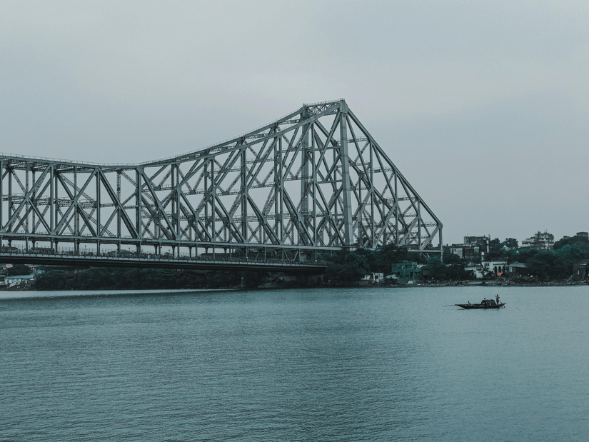 Howrah bridge above the Hooghly River on a cloudy day.