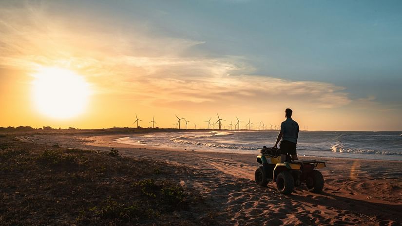 A Man Riding Atv on Beach during Sunset