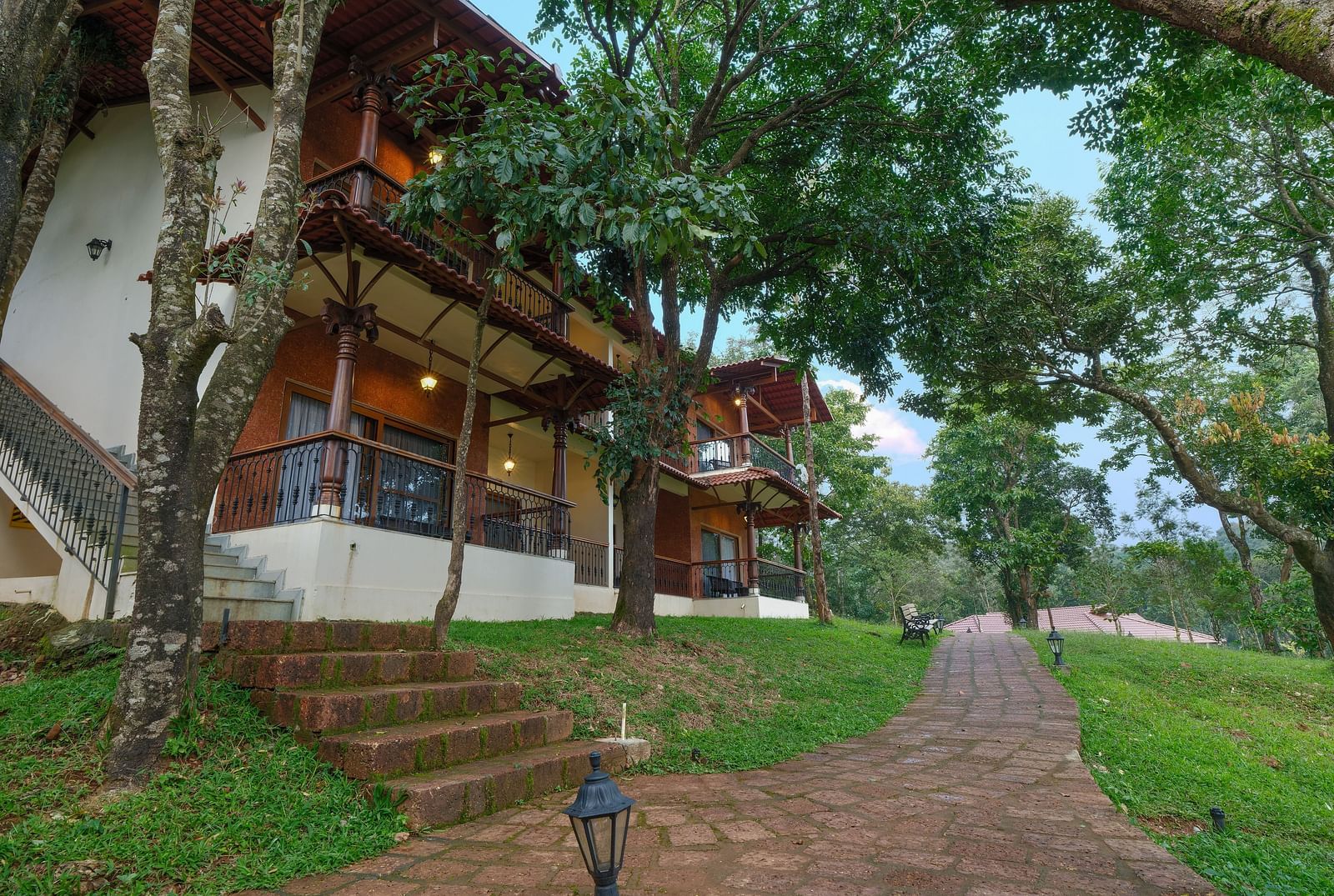 A facade image of a cottage covered in lush greenery