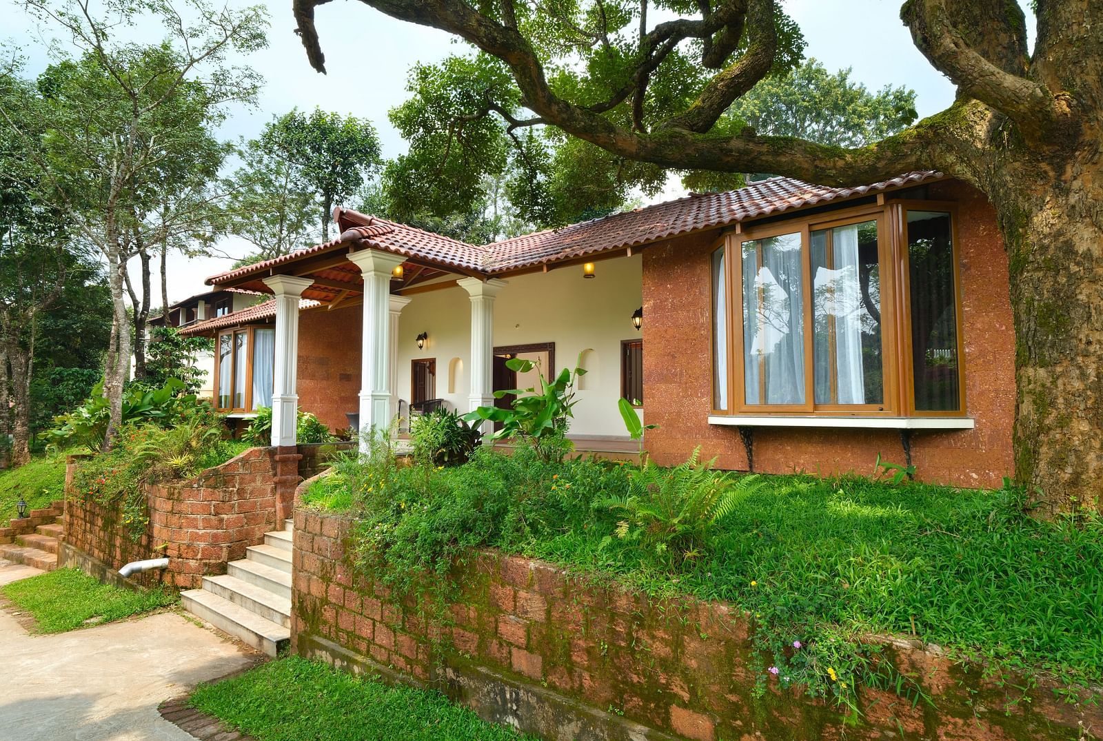 A cottage at our resort surrounded by green trees