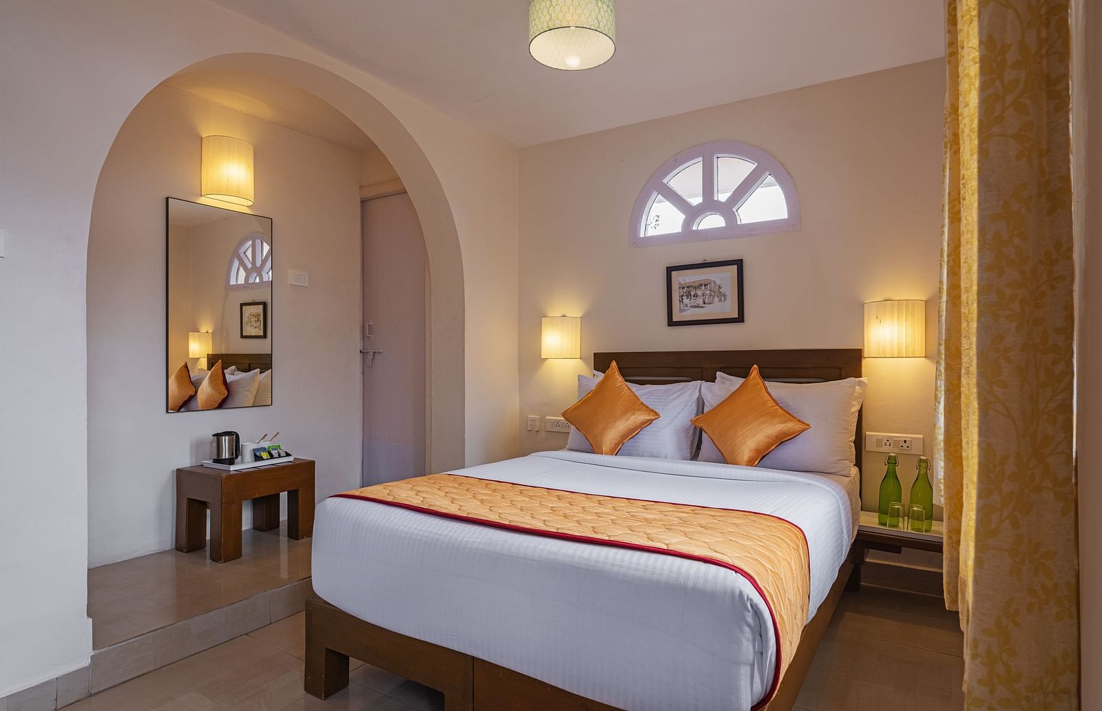 A bedroom with double-sized bed, lamps on each side ansd other amenities included | Mango Hill, Kodaikanal