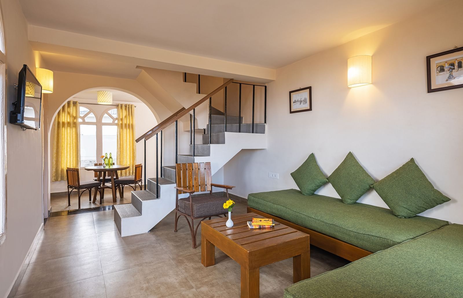 An image of a sitting room and a flight of stairs leading on the corner leading to first floor | Mango Hill, Kodaikanal