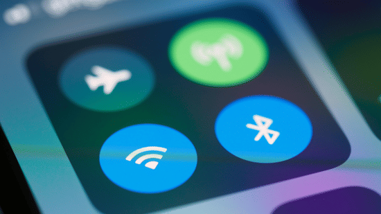 Close-up of smartphone screen showing WiFi, Bluetooth, airplane mode, and hotspot icons in control center.