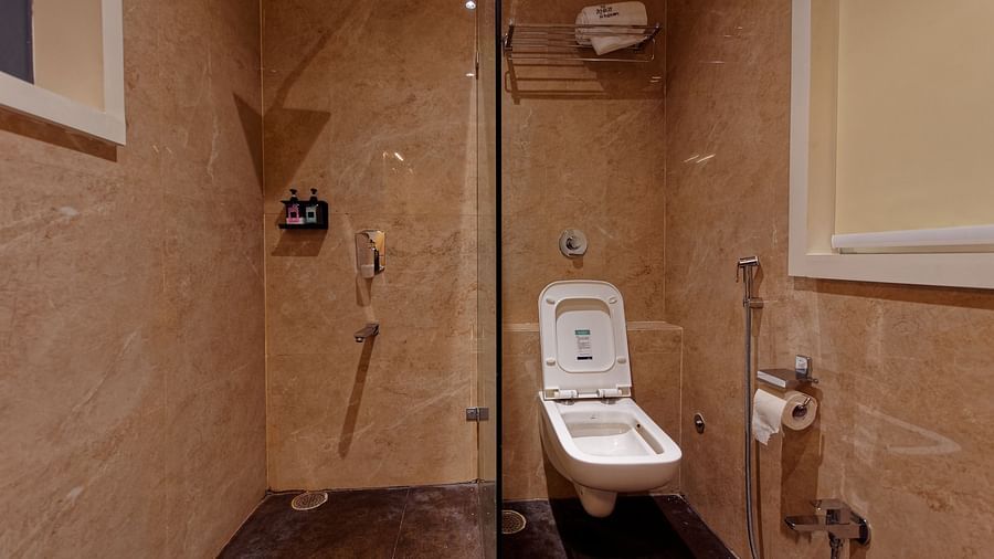 Image of a washroom with modern amenities and seperate shower cublicle at Ankit Hotel, Jabalpur