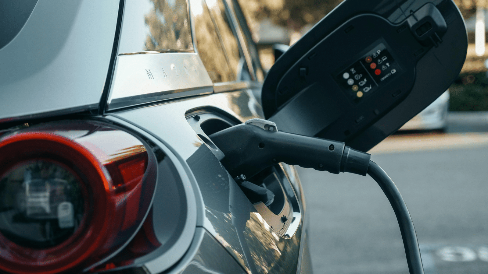 Close up shot of a car getting charged at an electric vehicle station. 