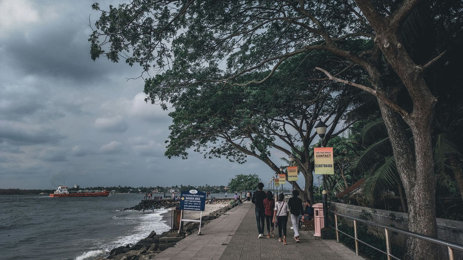 Footpath alongside the beach where people are strolling