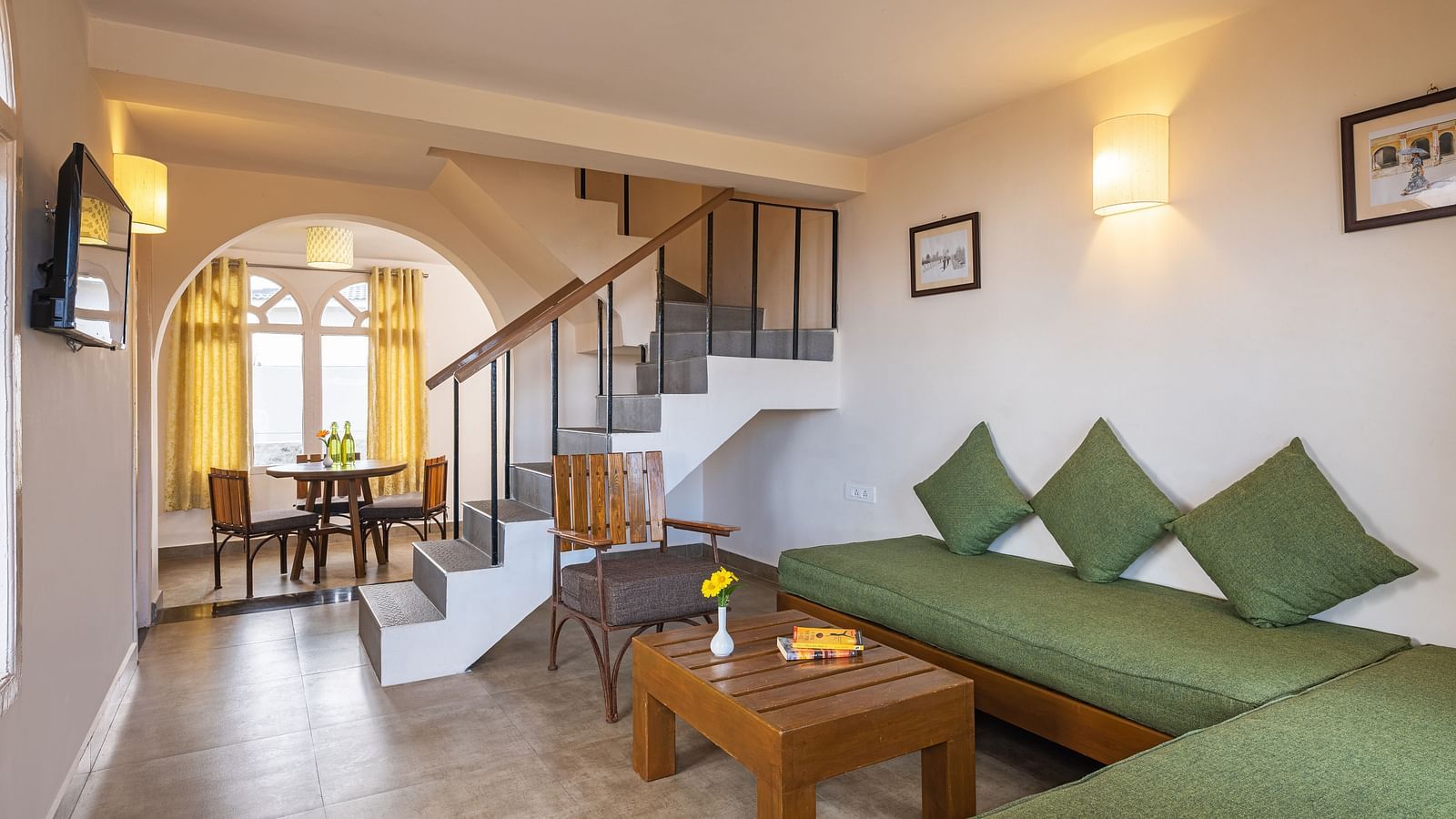 An image of a sitting room and a flight of stairs leading on the corner leading to first floor | Mango Hill, Kodaikanal