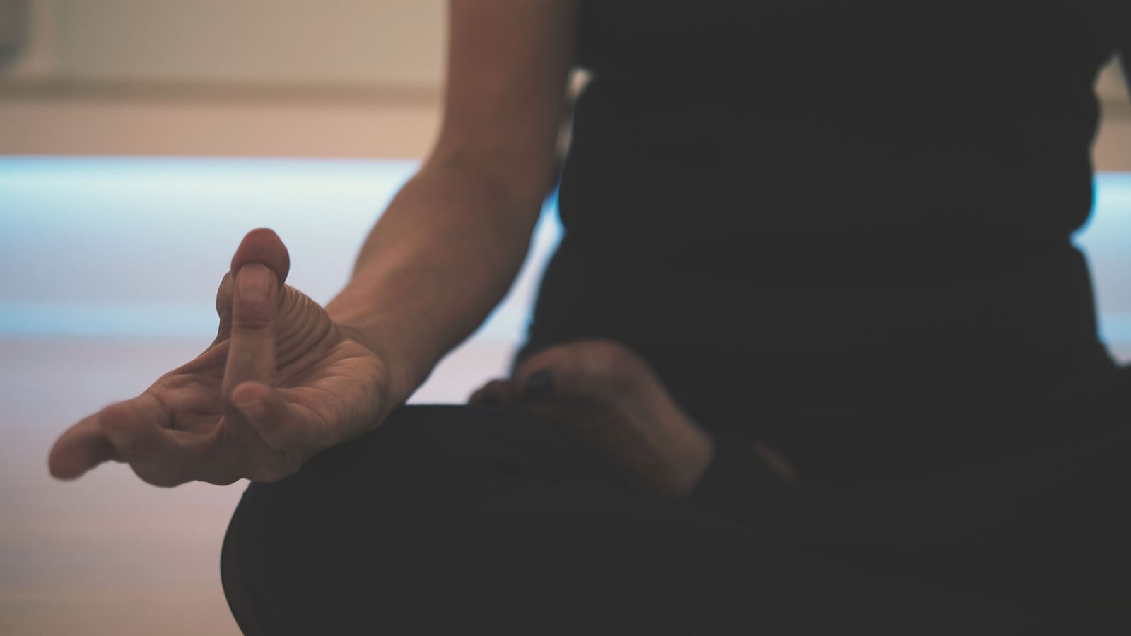 A person meditating in an indoor space