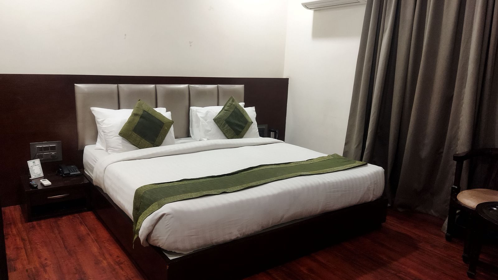 Another view of a hotel room with a green runner on the bed, a seating area - TGI Apple Inn, Jaipur 