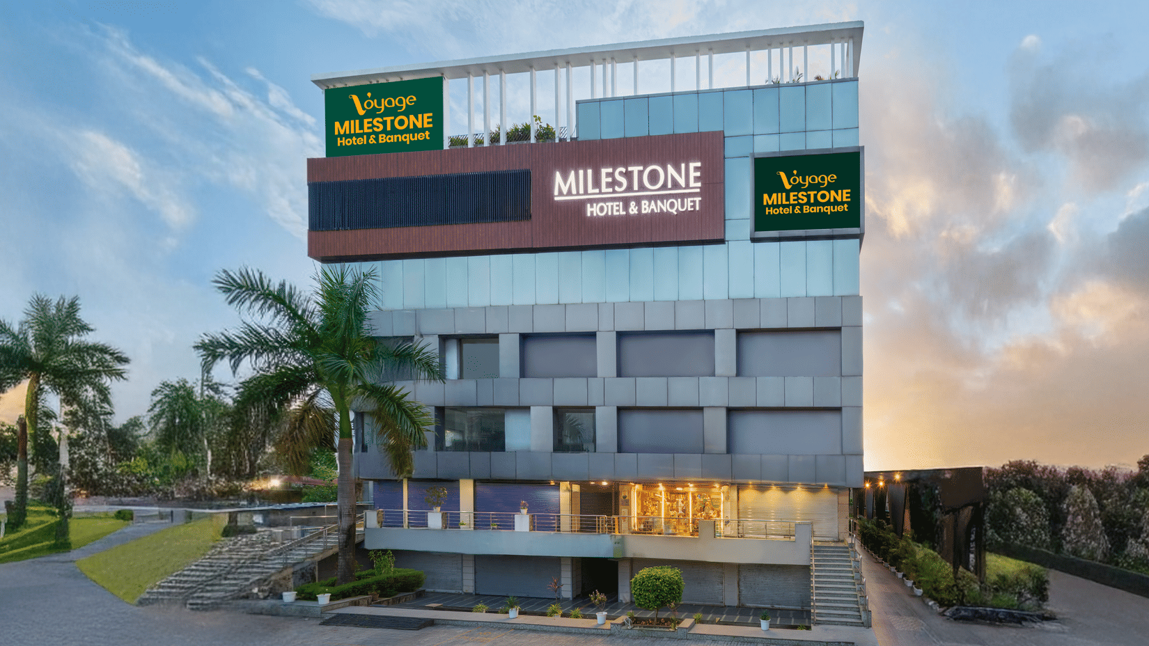 Exterior view of Voyage Milestone Hotel and Banquet with main entrance and signage.
