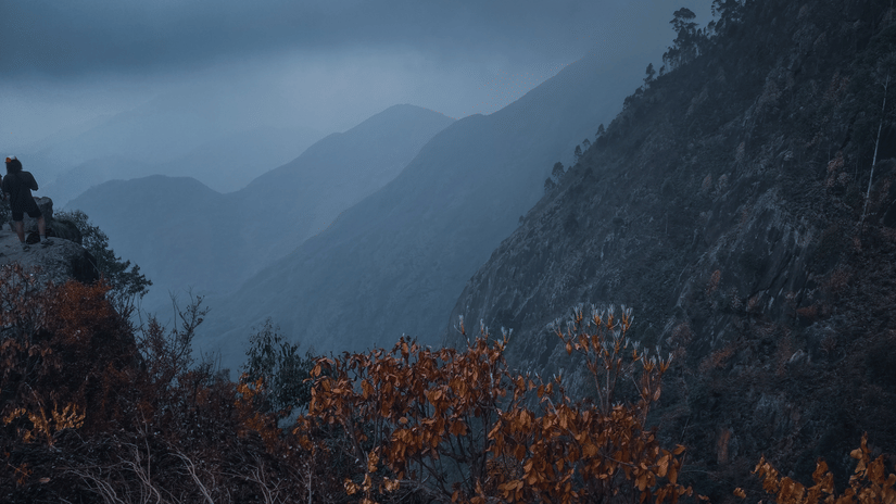 a view of mountains covered in fog as far as the eye can see.