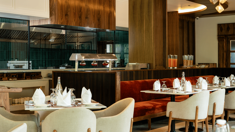 Elegant restaurant interior at Mountnoor Sarovar Premiere, Pahalgam with modern décor and refined dining ambience.