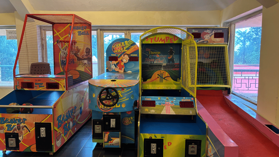 The hotel arcade with various arcade gaming consoles lined up side by side.