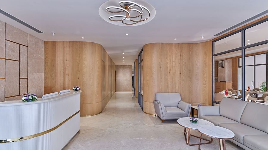 Elegant hotel lobby with comfortable seating, artwork, and a modern chandelier - Biznotel by Pride Motera, Ahmedabad