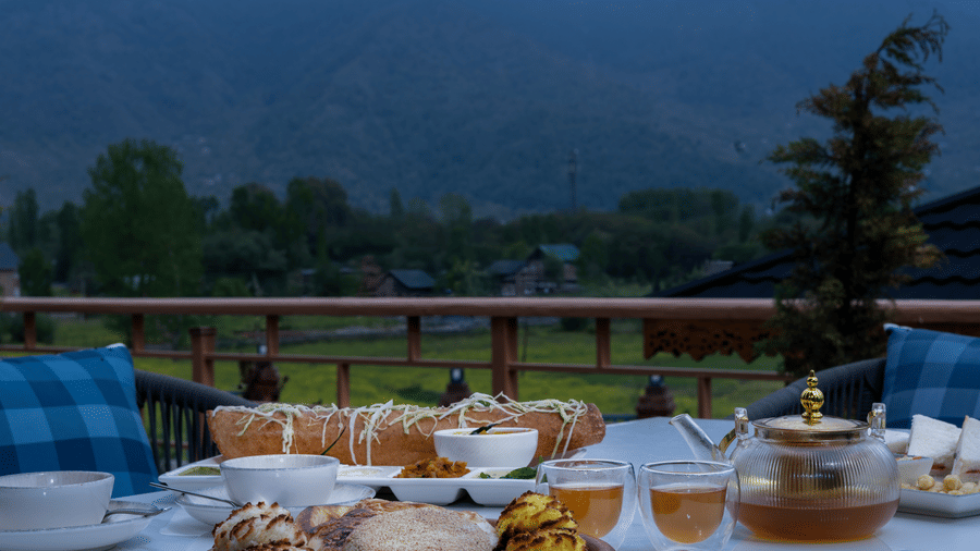 Outdoor dining setup at Mountnoor Sarovar Premiere, Pahalgam with scenic mountain views and elegant table arrangements.