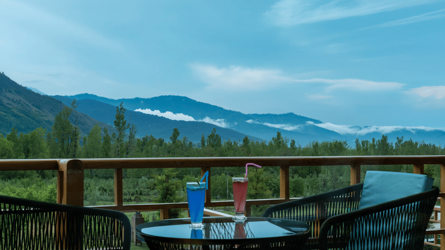 Private balcony at Mountnoor Sarovar Premiere, Pahalgam offering panoramic mountain and valley views.