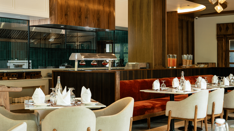 Elegant restaurant interior at Mountnoor Sarovar Premiere, Pahalgam with modern décor and refined dining ambience.