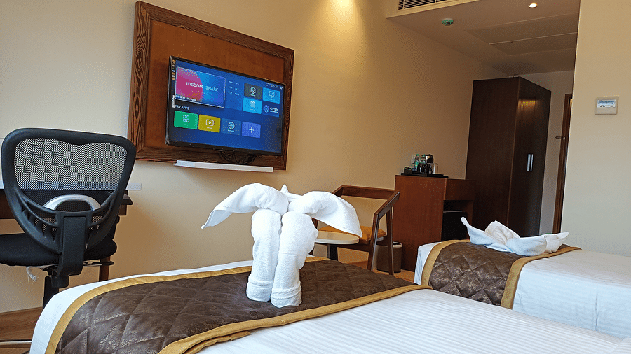 Bedroom with twin beds facing the TV-  Quality Inn Rockwell Grand