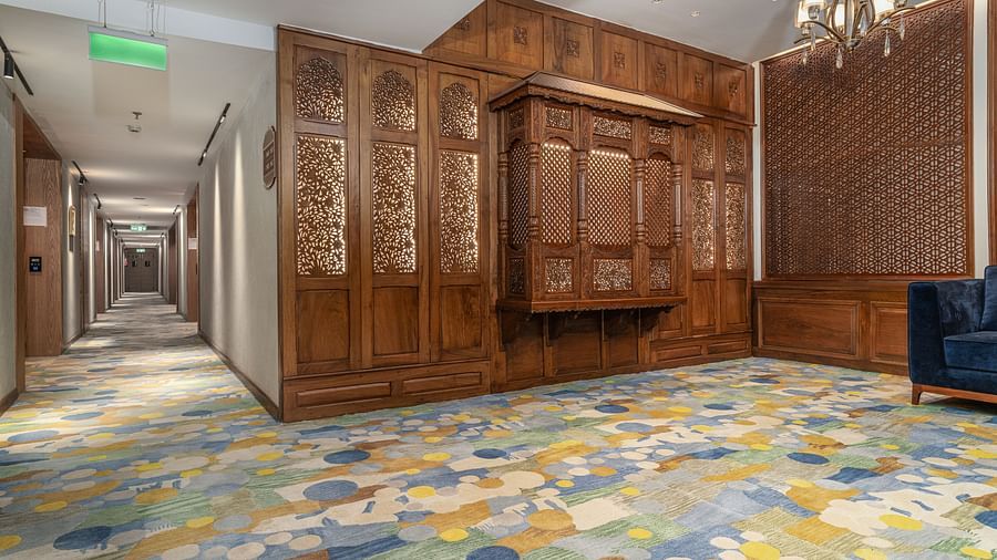 An image our corridor that leads to the rooms with wooden ascents and chandeliers - Sarovar Premiere, Srinagar