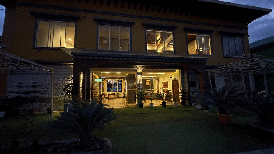 Facade view of Sumitel Gangtok in the night with the lights on inside the reception area