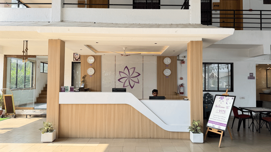 Reception area at VITS Daman Devka Beach featuring a welcoming front desk with modern interiors.