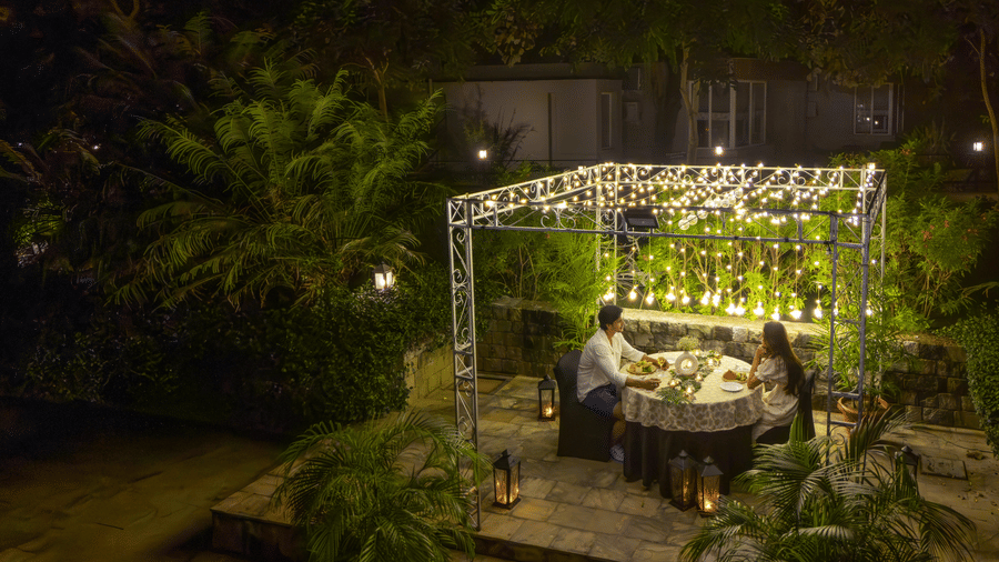 A night view of an outdoor dining area at The Golden Tusk, Jim Corbett
