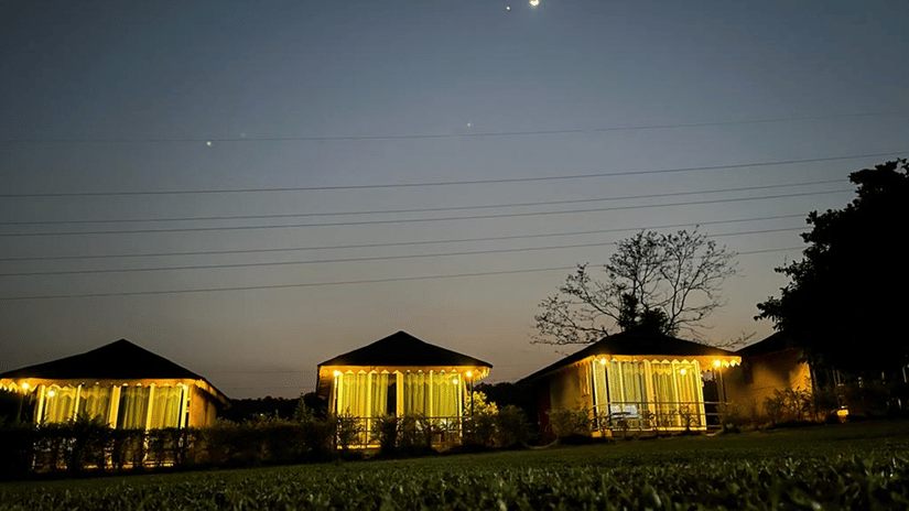 Night view of illuminated cottages with moonlight in the sky at Nature Trails Durshet.