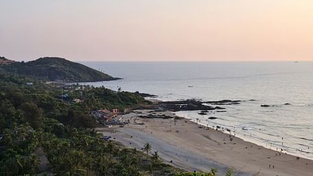 An overview of vagator beach in Goa with forest cover meeting the sea