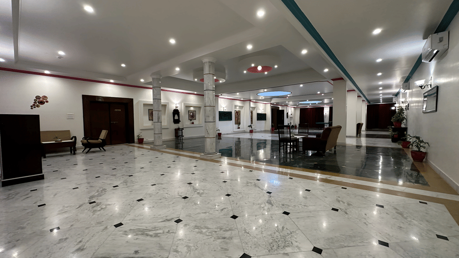 A spacious lobby area with marble flooring and ceiling lights at AS Hotels, Khajuraho.