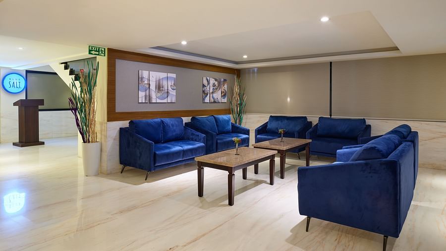 Well-lit lobby area of Essentia Premier Hotel, Chennai with sofa seating and a coffee table