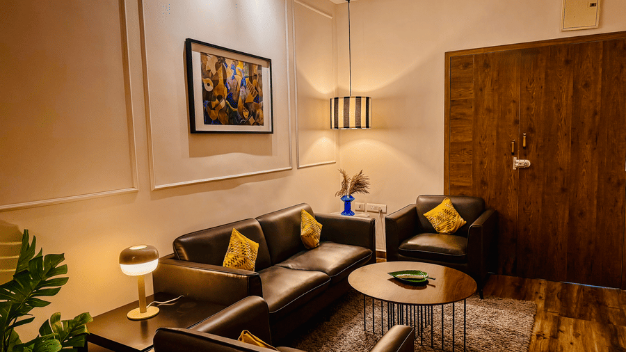 Separate living room of Coral 4BHK at Kove Smart Stays seen under ambient lighting.