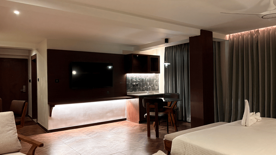 Comfortable wooden armchairs and desk area within the guest room - Lords Riverside Resort, Muduba - Shivamogga