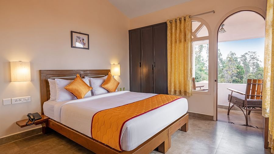 An image of large bedroom with doubled-sized bed and a balcony attached | Mango Hill, Kodaikanal